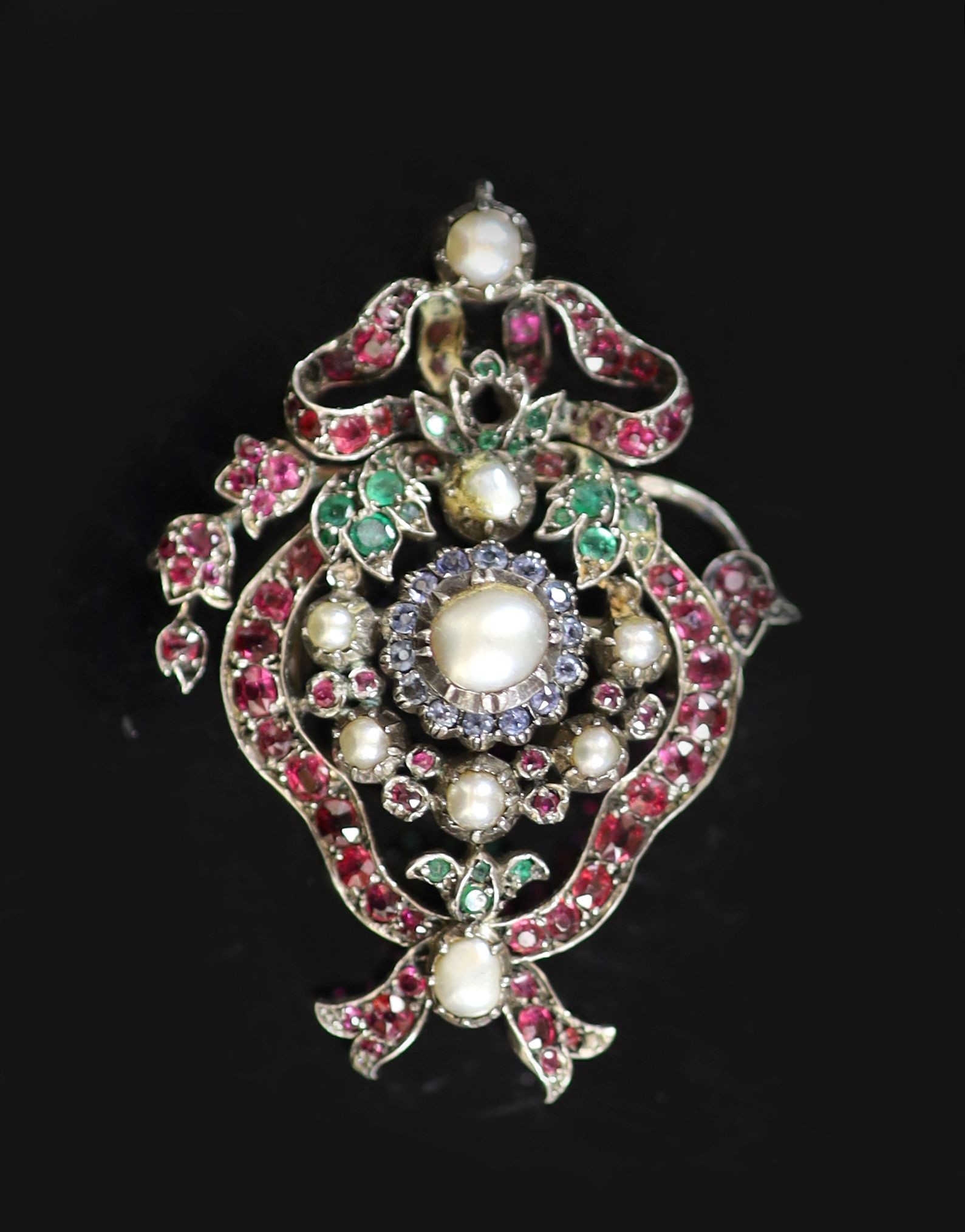 A 19th century Austro Hungarian silver and gold, ruby, sapphire, emerald and split pearl gem set pendant brooch
